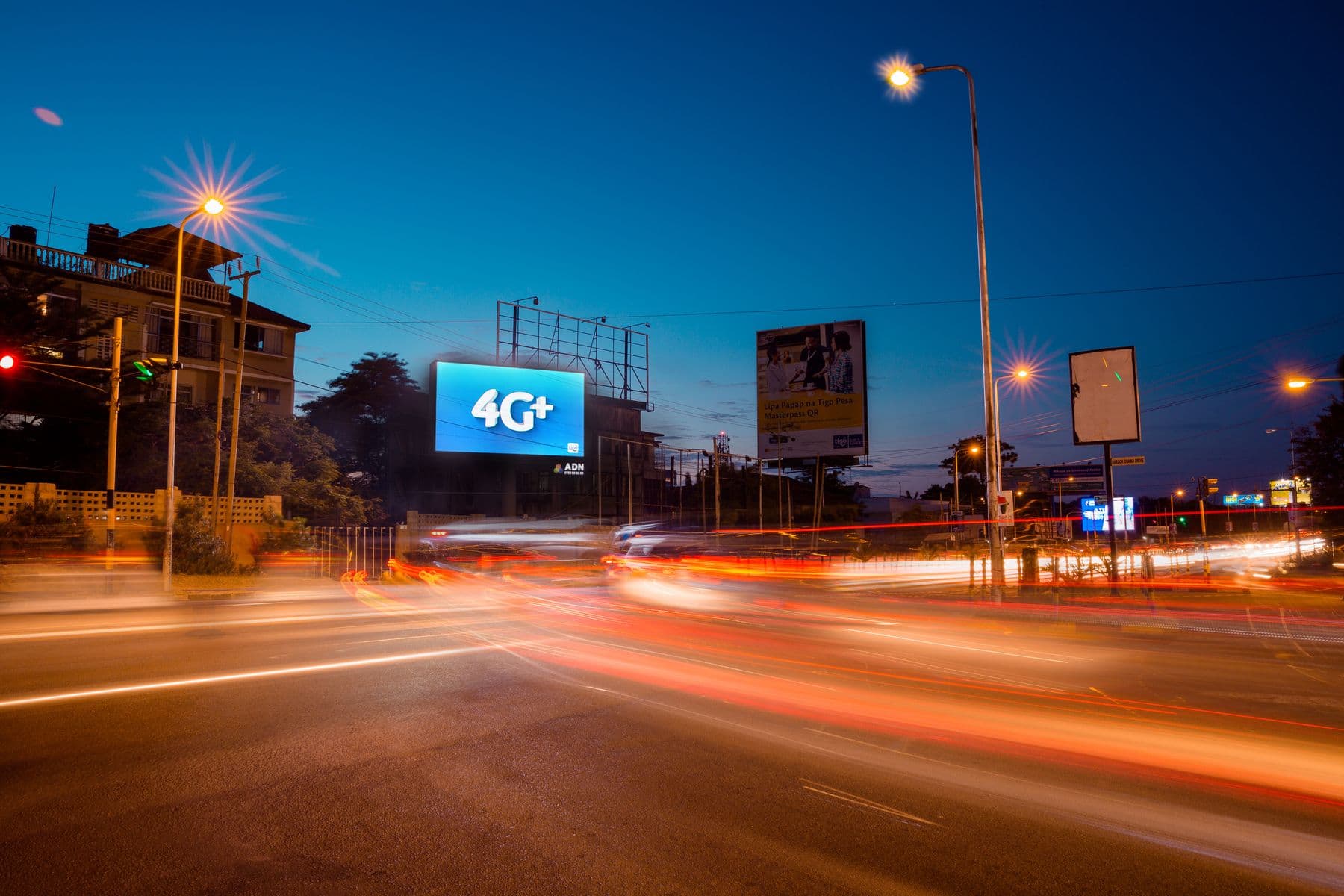 A digital screen over a junction in Dar es Salaam at night