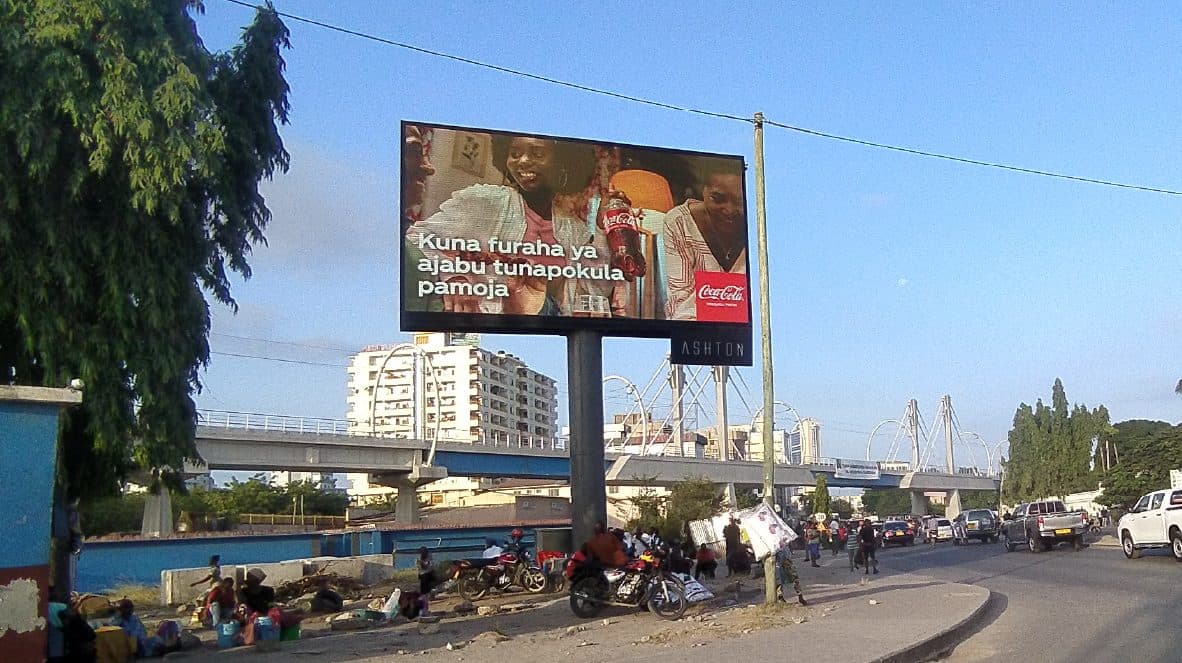 A Coca-Cola billboard beside a flyover