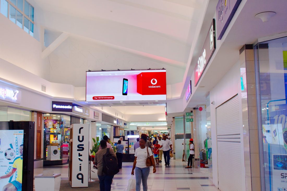 A Vodacom screen in the mall corridor near the iStore